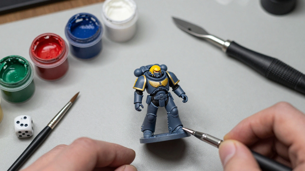 Процесс покраски миниатюры Warhammer на рабочем столе с красками и кистями